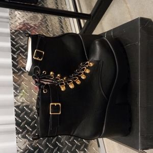 Black moto boots with a heel.